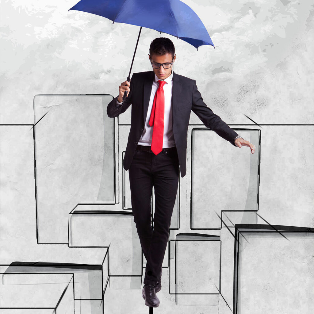 Na grafice ilustrującej tekst widzimy mężczyznę w garniturze i pod krawatem, z parasolem, który ostrożnie porusza się wśród konturów klocków.
