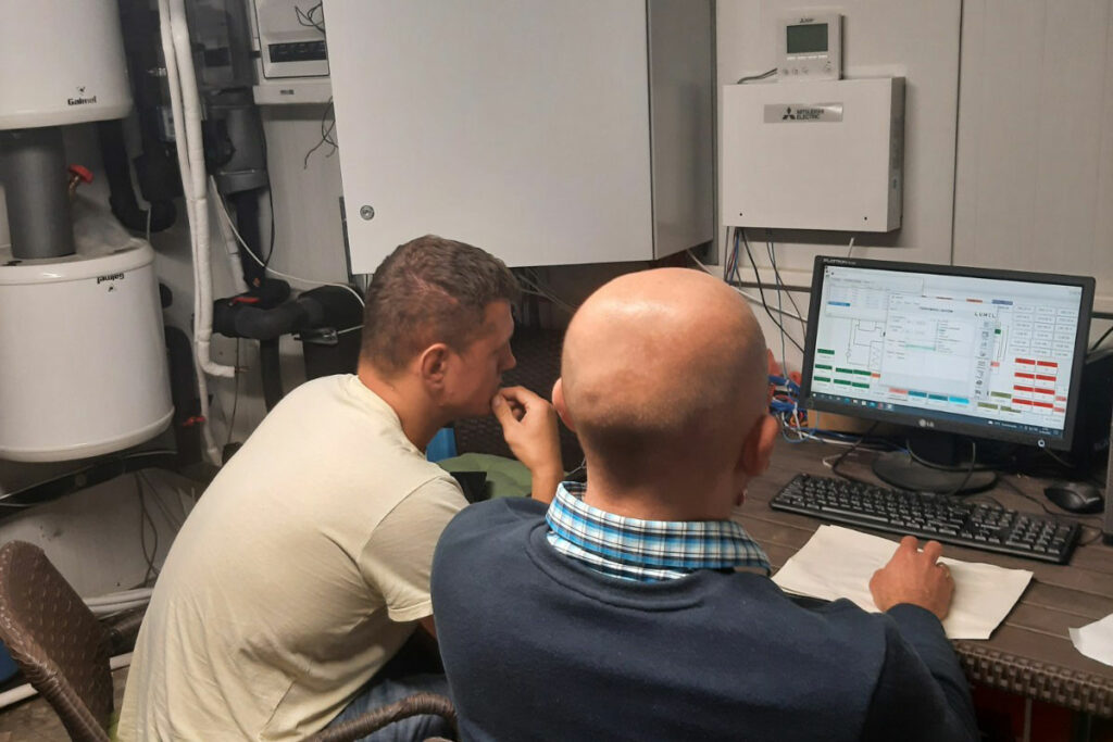 Fotografia ukazuje dwóch mężczyzn w skupieniu pracujących przy komputerze. Zdjęcie pochodzi z archiwum firmy EcoStrus.