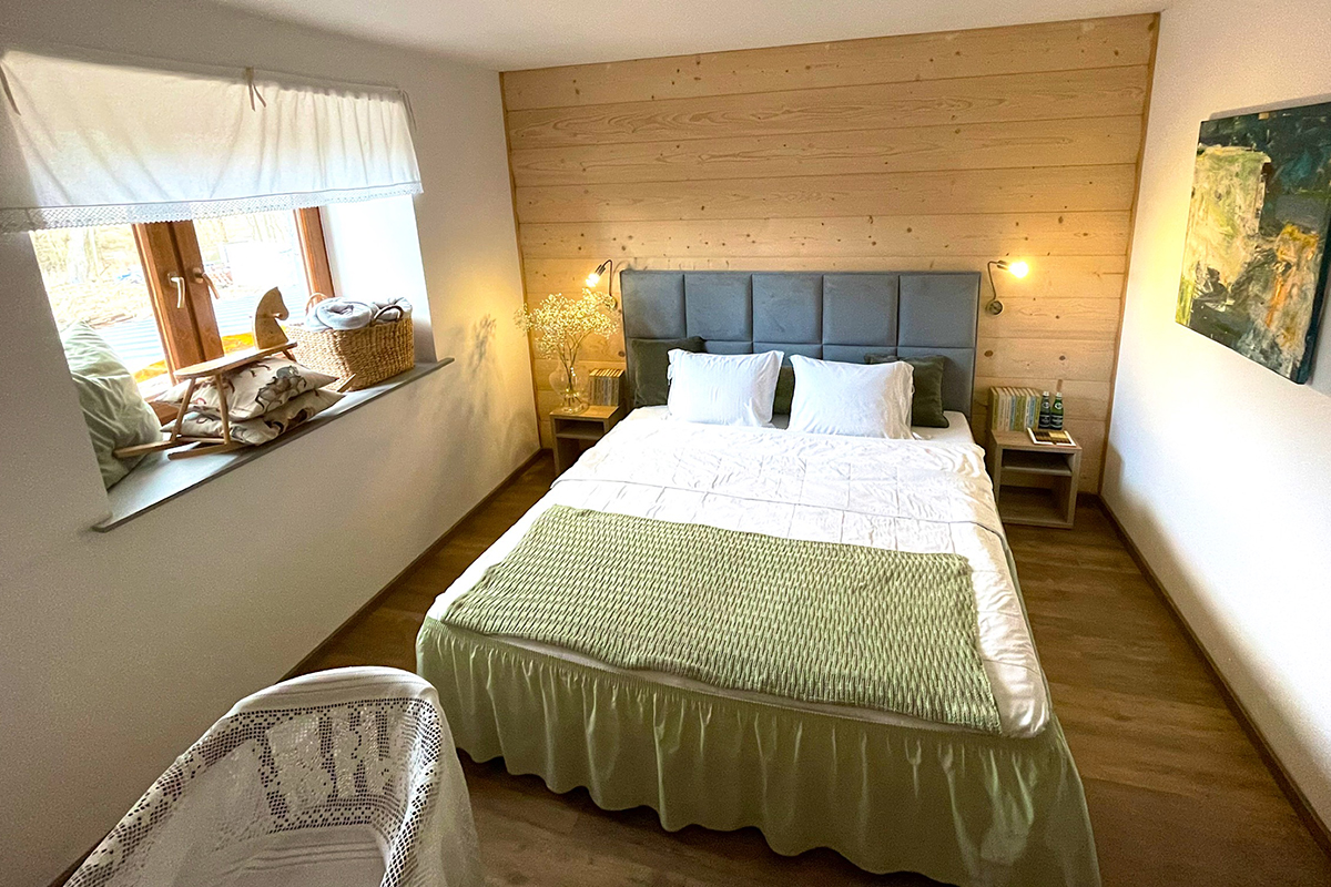 Zdjęcie ukazuje pokój hotelowy z dużym, dwuosobowym łóżkiem.